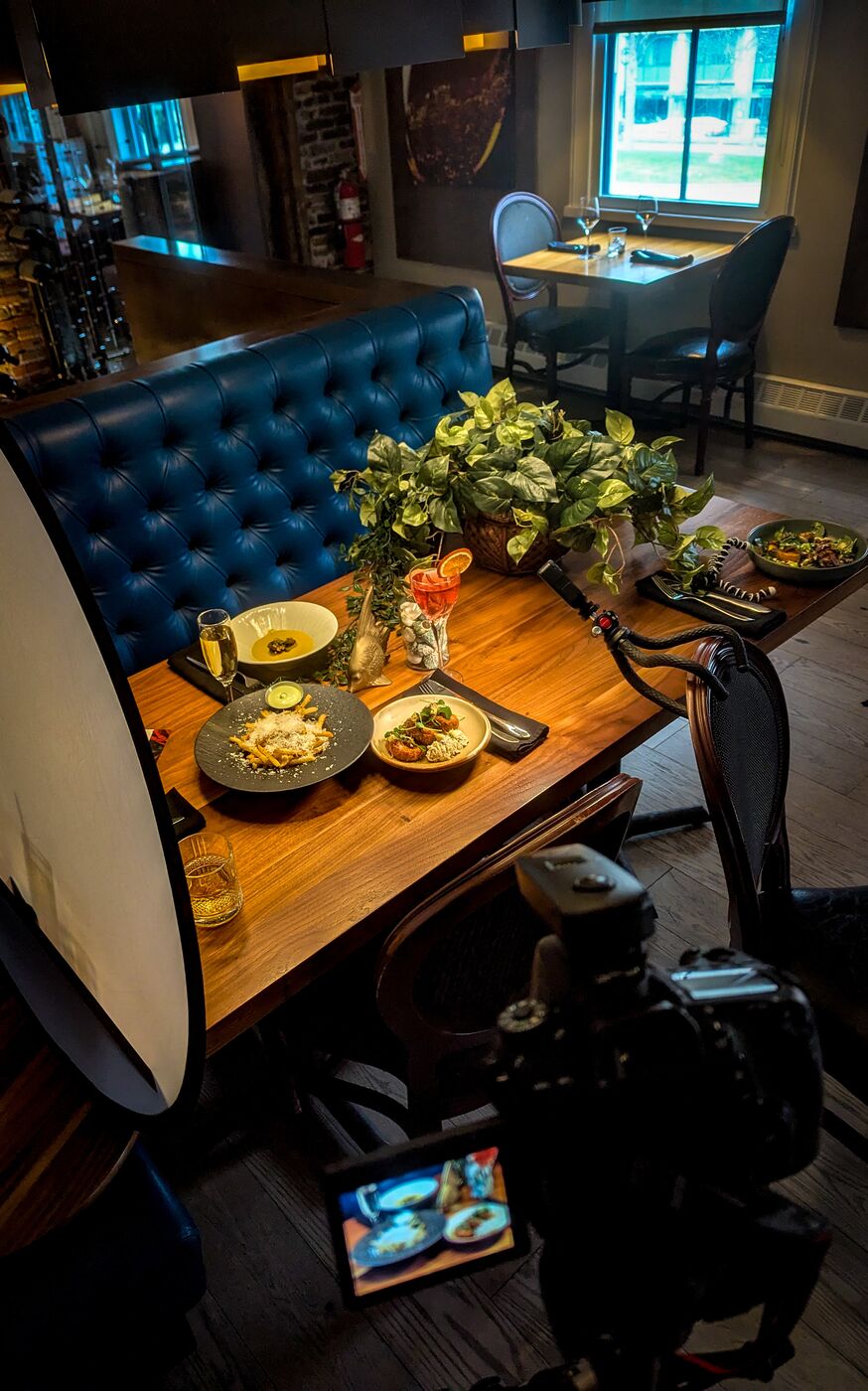 Behind the scenes: lighting and camera setup at a restaurant table